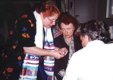 Rabbi David rolls parchment for mezuzzah.